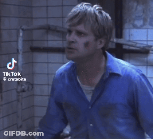 Man Lying On Ground With Chain Around Neck GIF