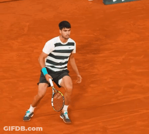 A Man Is Laying On The Ground With A Tennis Racquet On The Ground GIF