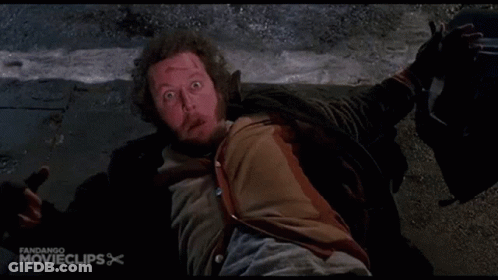 A Man Is Laying On The Ground With His Mouth Open In A Movie Clip GIF