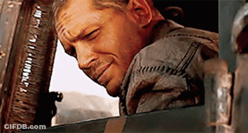 A Man Is Leaning His Head Out Of A Window And Smiling .. GIF