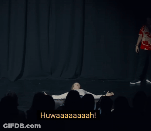 A Man Is Levitating In Front Of A Crowd With The Words Levitating Below Him GIF