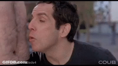 A Man Is Licking Another Man 'S Ear In A Movie Scene . GIF