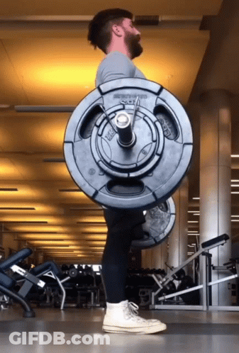 A Man Is Lifting A Barbell In A Gym That Says ' Smith ' On The Barbell GIF
