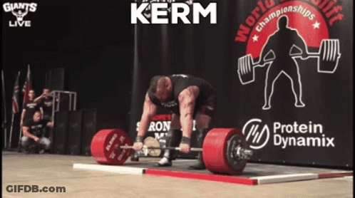 A Man Is Lifting A Barbell In Front Of A Sign That Says Kerm GIF