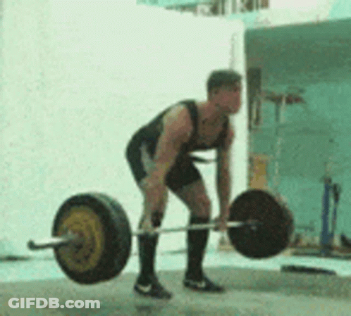 A Man Is Lifting A Barbell On A Concrete Surface . GIF