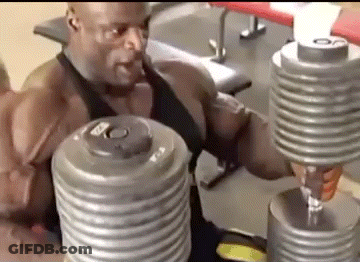 A Man Is Lifting Dumbbells In A Gym While Sitting On A Bench . GIF
