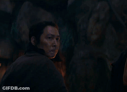 A Man Is Looking At A Blue Light Beam GIF
