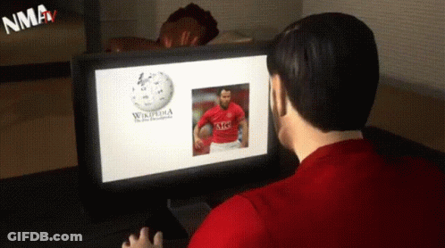 A Man Is Looking At A Computer Screen That Says Wikipedia GIF