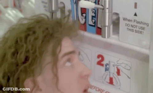 A Man Is Looking At A Sign That Says " When Flashing Do Not Use This Side " GIF