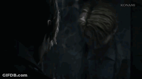 A Man Is Looking At Himself In A Mirror . GIF