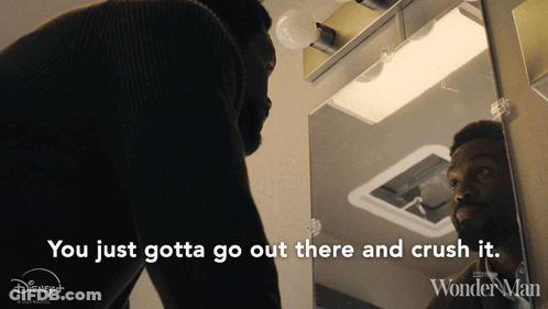 A Man Is Looking At Himself In A Mirror With The Words You Just Gotta Go Out There And Crush It GIF