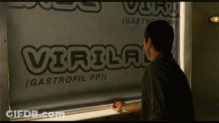 A Man Is Looking Out A Window At A Sign That Says Virulog GIF