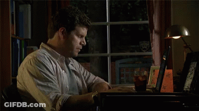 A Man Is Looking Out A Window At A Stuffed Animal That Is Holding A Knife In Its Hand . GIF