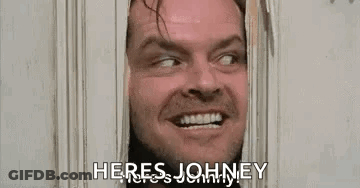 A Man Is Looking Through A Door With The Words `` Here 'S Johnny '' . GIF