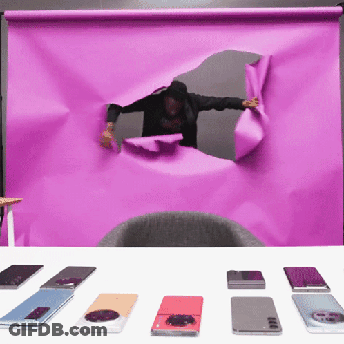 Man Looking Through Hole In Purple Paper GIF