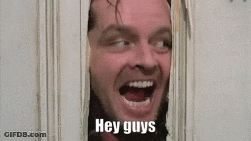 A Man Is Looking Through A Hole In A Wall With His Mouth Open And The Words `` Hey Guys '' Written On His Face . GIF