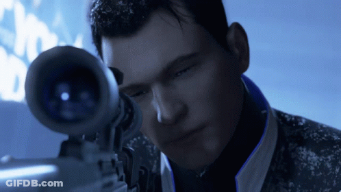 A Man Is Looking Through A Sniper Scope In A Dark Room GIF