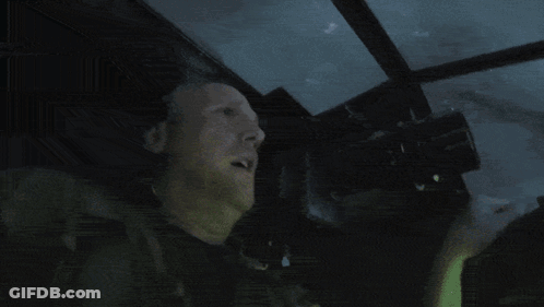 A Man Is Looking Through Binoculars With A Sign That Says ' Nikon ' On It GIF