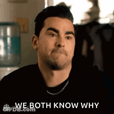 A Man Is Making A Face And Saying `` We Both Know Why '' While Sitting In Front Of A Water Cooler . GIF