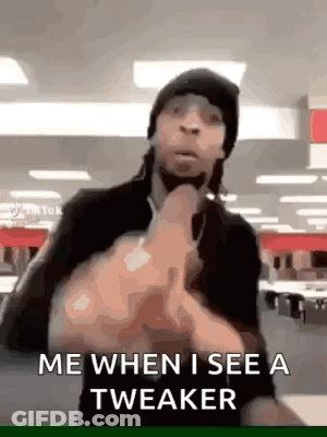 A Man Is Making A Funny Face And Giving The Middle Finger . GIF