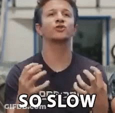 A Man Is Making A Funny Face And Saying `` So Slow '' With His Hands . GIF