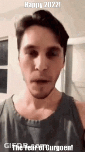 A Man Is Making A Funny Face And Says Happy 2022 The Year Of Gurgoen ! GIF