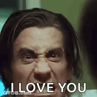 A Man Is Making A Funny Face And Says `` I Love You '' . GIF