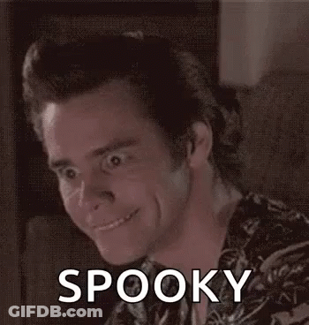 A Man Is Making A Funny Face And Smiling While Sitting On A Couch With The Word Spooky On His Face . GIF