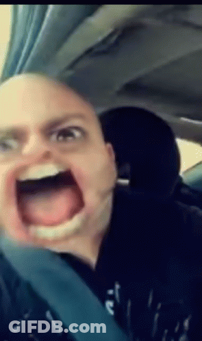 A Man Is Making A Funny Face In A Car GIF