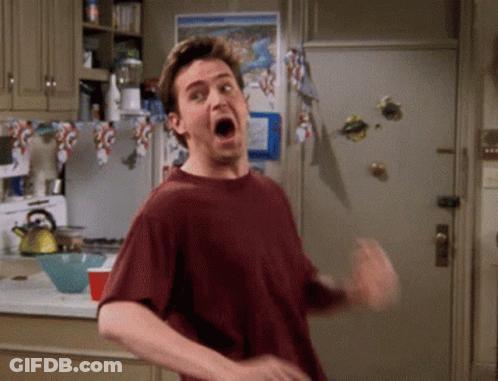 A Man Is Making A Funny Face In A Kitchen GIF