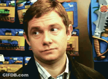 A Man Is Making A Funny Face In Front Of A Display Of Toy Guns GIF