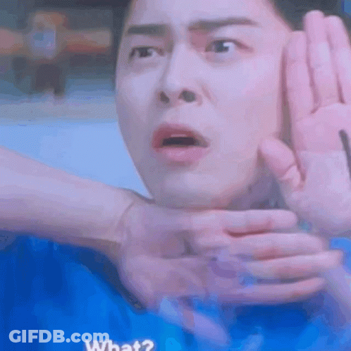 A Man Is Making A Funny Face While Being Held By Someone 'S Hands . GIF