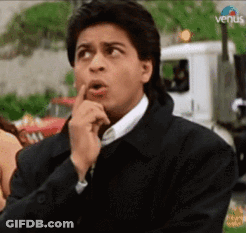 A Man Is Making A Funny Face While Holding His Finger To His Lips . GIF