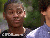 A Man Is Making A Funny Face While Looking At Another Man . GIF
