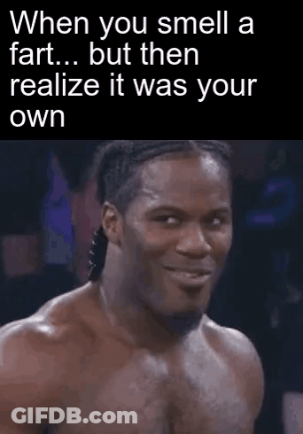 A Man Is Making A Funny Face While Smelling A Fart . GIF
