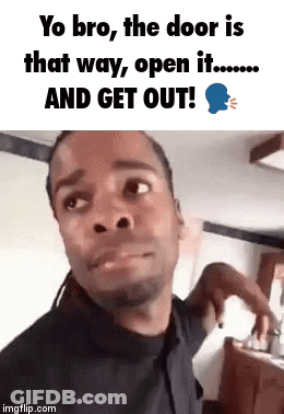 A Man Is Making A Funny Face While Standing In Front Of A Door . GIF