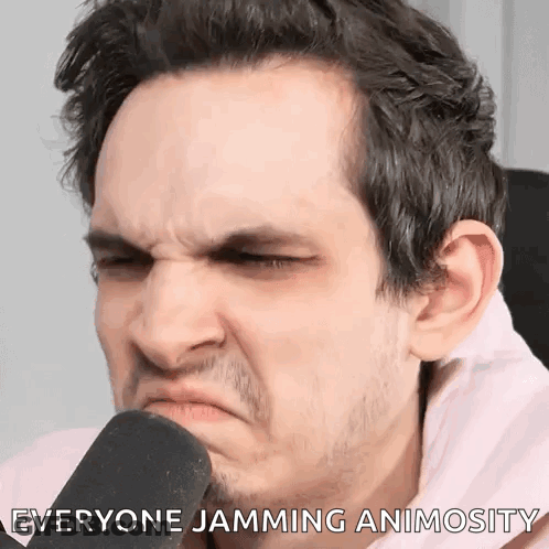 A Man Is Making A Funny Face While Talking Into A Microphone With The Words " Everyone Jamming Animosity " Written Below GIF