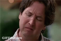A Man Is Making A Funny Face With His Eyes Closed And His Mouth Open . GIF