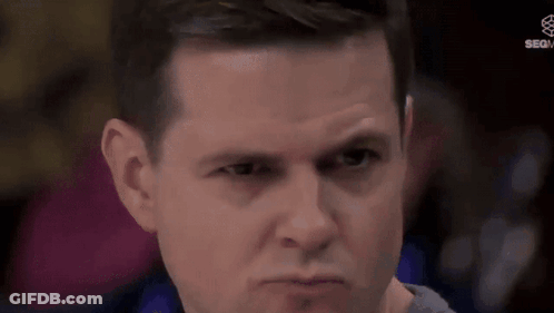 A Man Is Making A Funny Face With His Eyes Closed . GIF