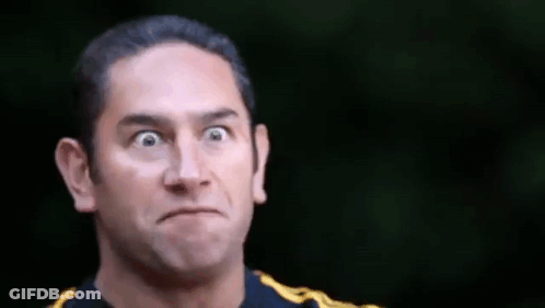 A Man Is Making A Funny Face With His Eyes Closed . GIF