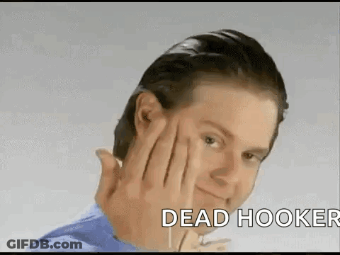 A Man Is Making A Funny Face With His Hand On His Forehead And The Words Dead Hooker Behind Him . GIF