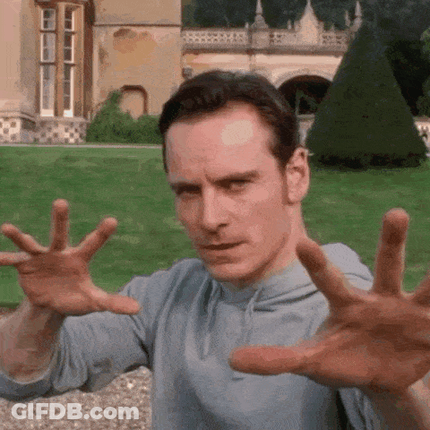 A Man Is Making A Funny Face With His Hands In The Air . GIF