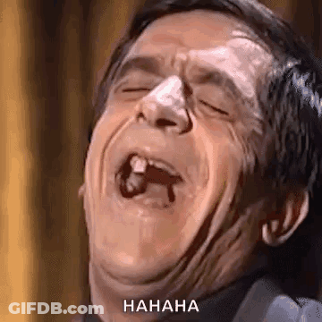 A Man Is Making A Funny Face With His Mouth Open And A Tooth Missing . GIF