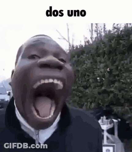 A Man Is Making A Funny Face With His Mouth Open And His Tongue Out . GIF