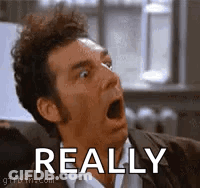 A Man Is Making A Funny Face With His Mouth Open And The Word Really Behind Him . GIF