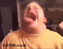 A Man Is Making A Funny Face With His Mouth Wide Open . GIF