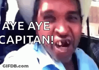 A Man Is Making A Funny Face With The Words Aye Aye Capitan Written Above Him GIF