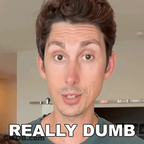 A Man Is Making A Funny Face With The Words " Really Dumb " Behind Him GIF