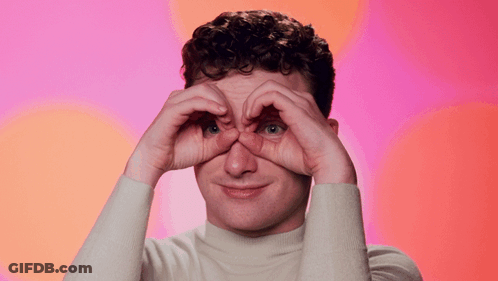 A Man Is Making A Heart Shape With His Hands And The Words Blink Blink Are Above Him GIF