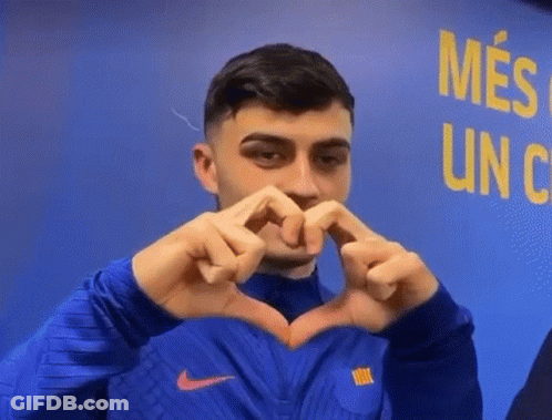 A Man Is Making A Heart Shape With His Hands . GIF